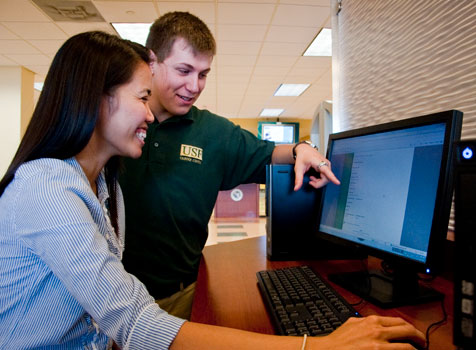 A career services worker assists a smiling student