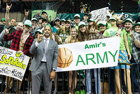 Coach amir amidst a crowd of students in the stands